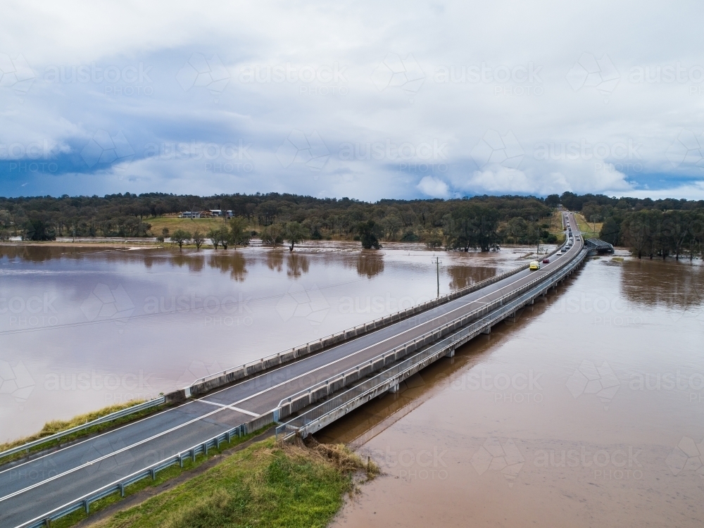 Redbournberry bridge near Singleton surrounded by floodwater during natural disaster of flood - Australian Stock Image