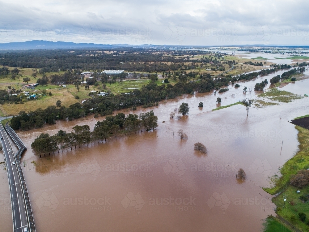 Redbournberry bridge near Singleton surrounded by floodwater during natural disaster of flood - Australian Stock Image