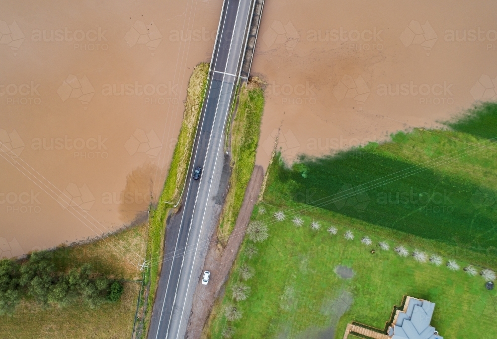 Redbournberry bridge near Singleton surrounded by floodwater during natural disaster of flood - Australian Stock Image