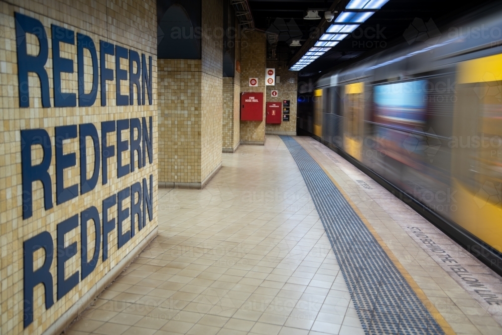 Redfern station with train approaching - Australian Stock Image