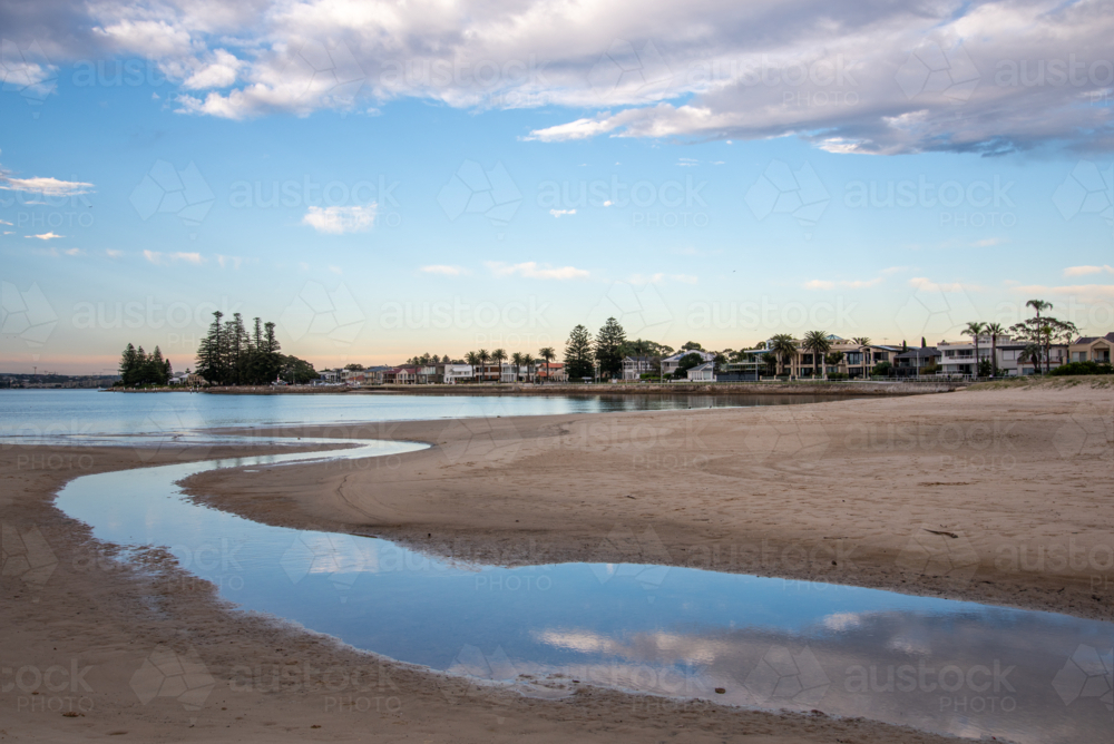 Reflections of clouds in water at Lady Robinsons Beach - Australian Stock Image