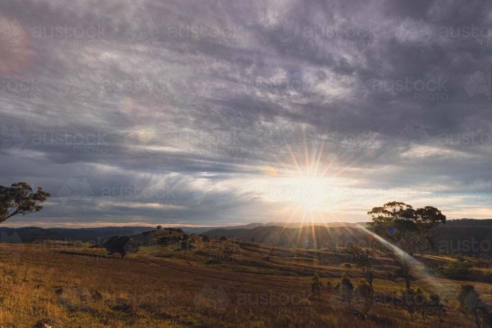 Image of Regional NSW sunset landscape with wind turbines on ridgeline ...