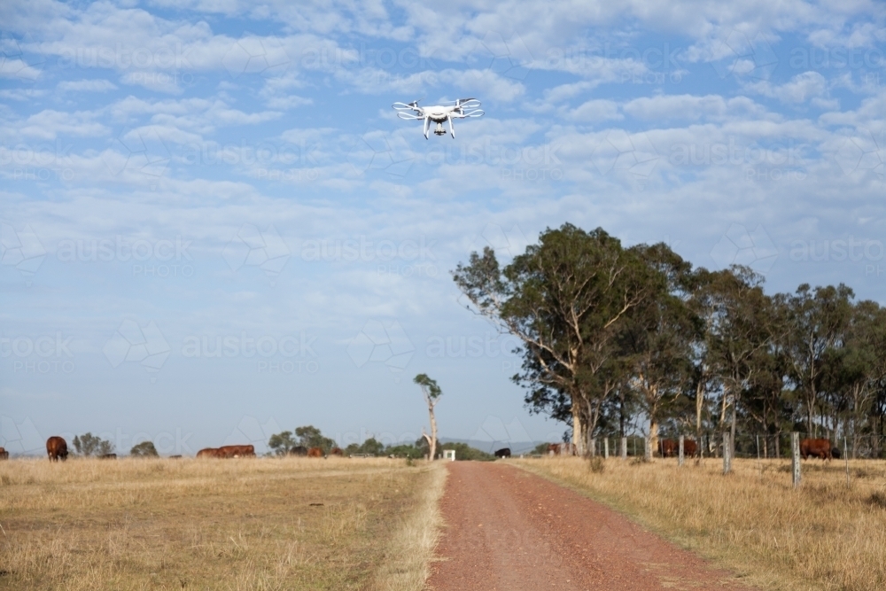 Remotely piloted aircraft flying over farm driveway - Australian Stock Image