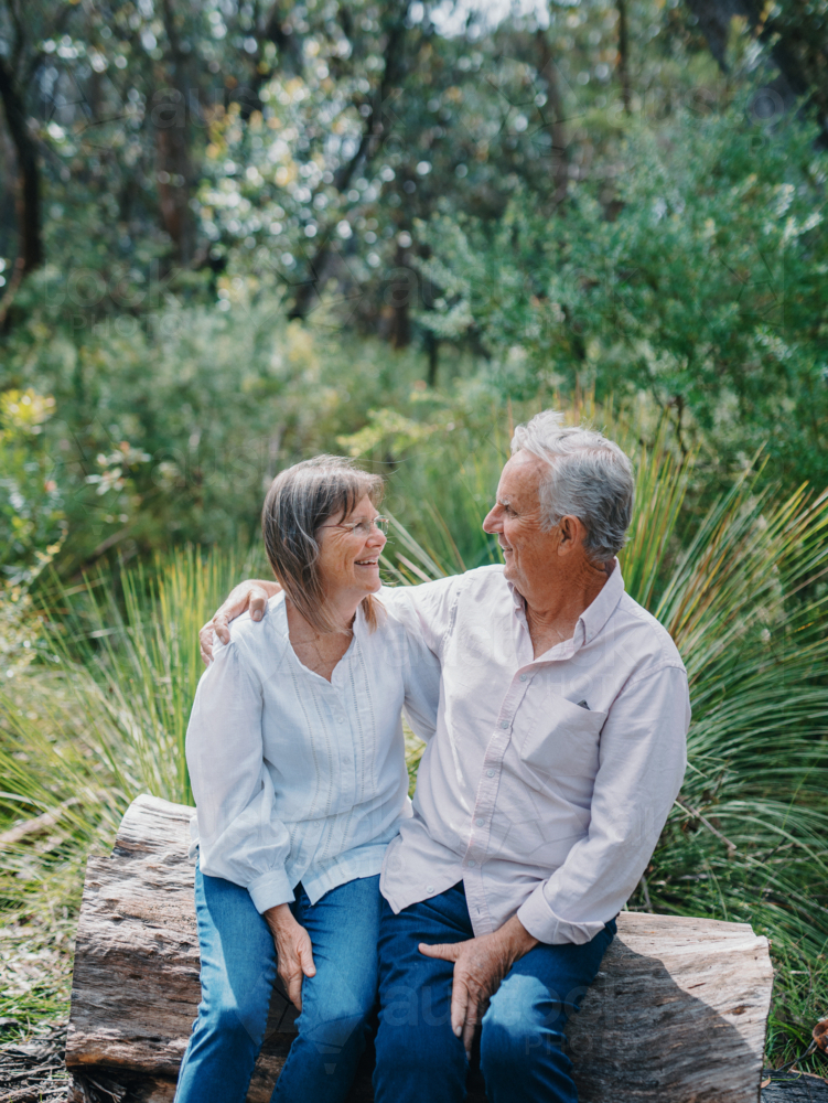 Retired senior couple sitting together enjoying healthy lifestyle in nature - Australian Stock Image