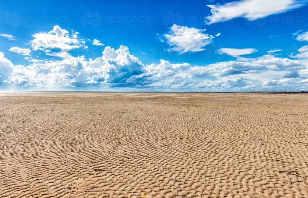 ripples on sandy beach at low tide - Australian Stock Image