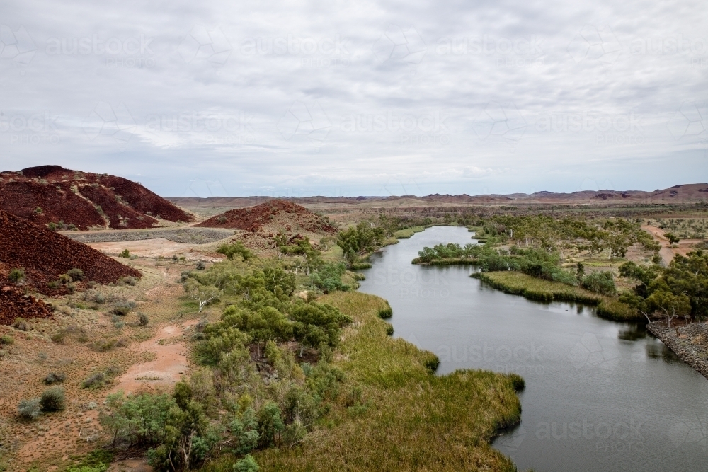 river in the Pilbara under cloudy sky - Australian Stock Image