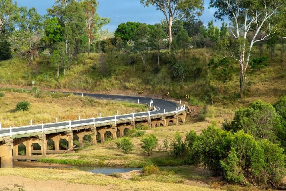 Road and bridge over Burnett River in rural Queensland. - Australian Stock Image