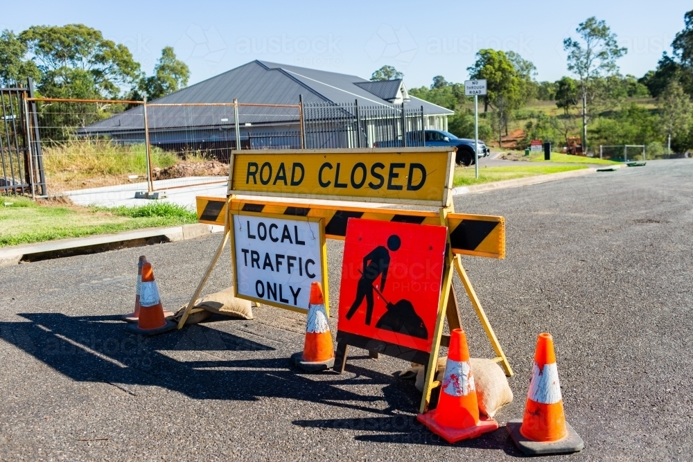 Road closed local traffic only sign with witches hat cones for roadwork resurfacing - Australian Stock Image