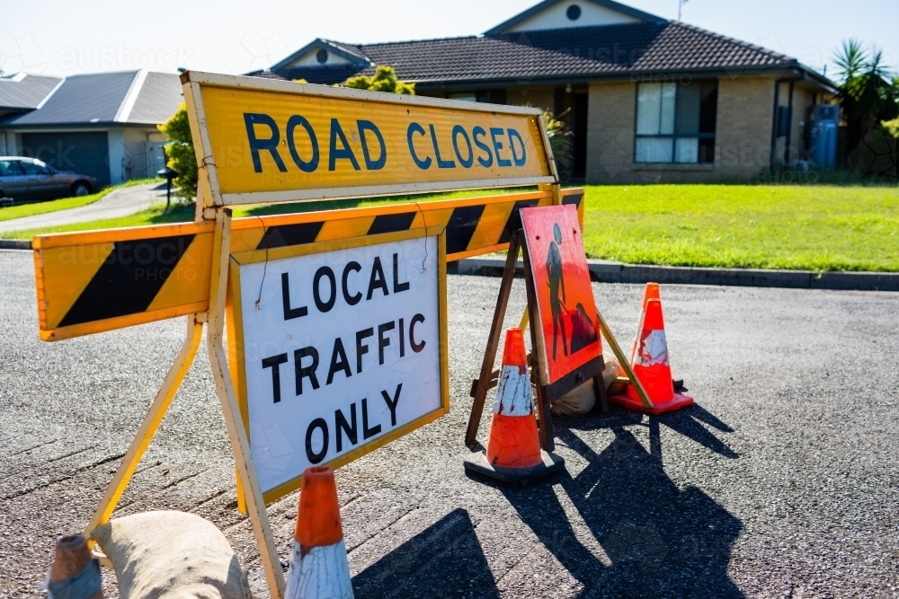 Road closed local traffic only sign with witches hat cones for roadwork resurfacing - Australian Stock Image