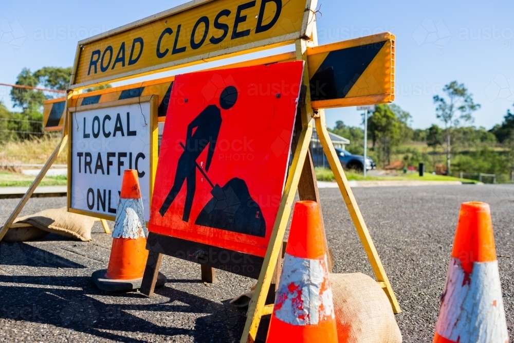 Road closed local traffic only sign with witches hat cones for roadwork resurfacing - Australian Stock Image