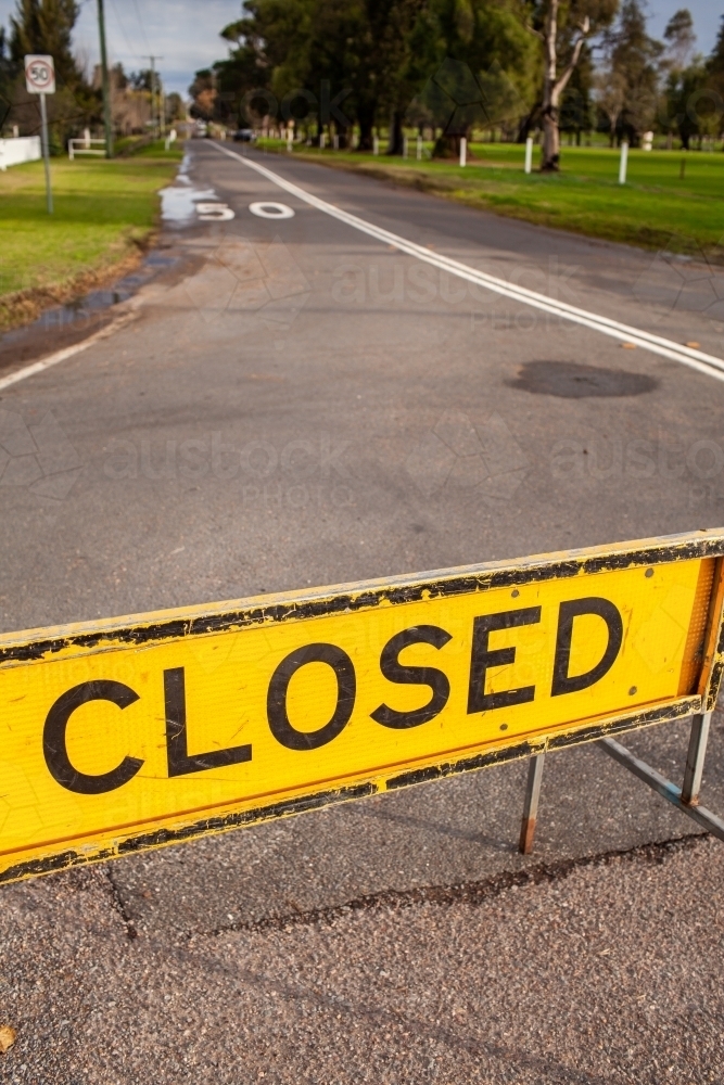 Road closed sign in town during flood - Australian Stock Image