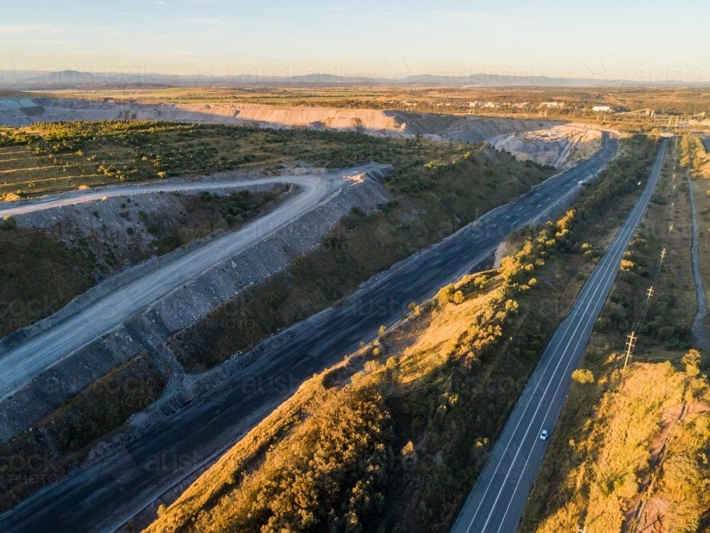 Road to Singleton past open cut coal mine in Hunter Valley - Australian Stock Image