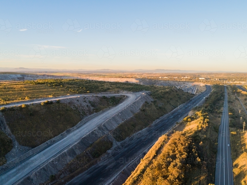 Road to Singleton past open cut coal mine in Hunter Valley - Australian Stock Image