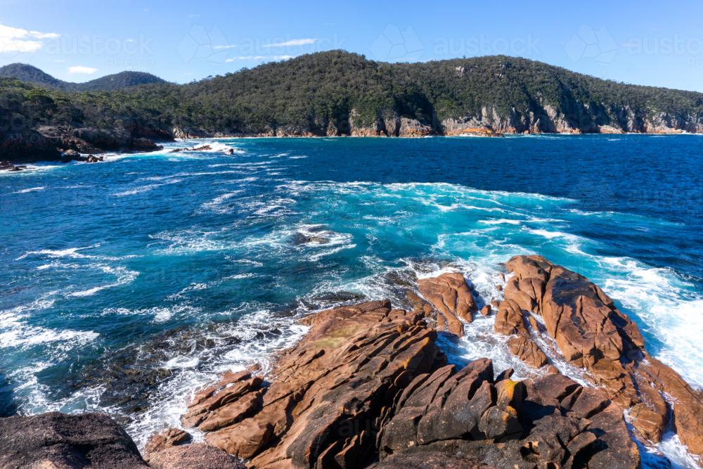 Rocks and waves at Sleepy Bay, Tasmania - Australian Stock Image