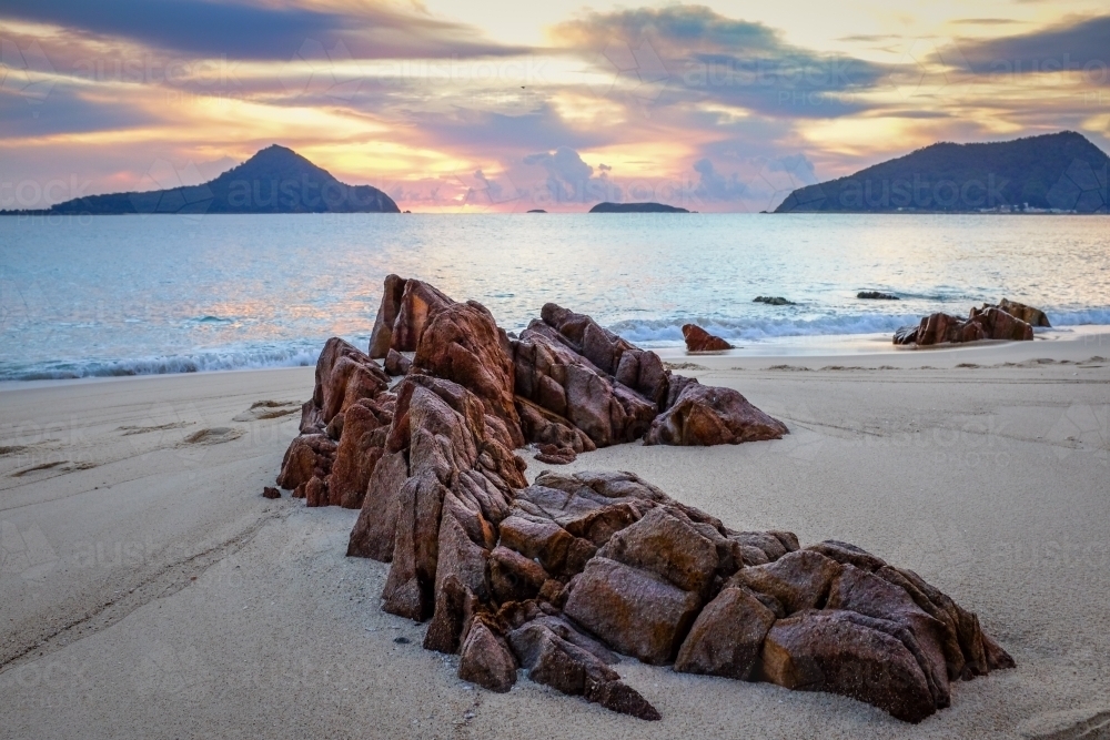 Rocky beach overlooking ocean and islands - Australian Stock Image