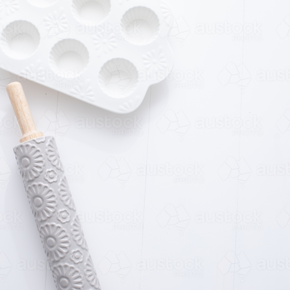 Rolling pin and muffin dish on blank background - Australian Stock Image