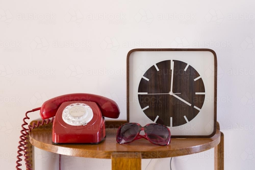 Rotary dial telephone and clock on display - Australian Stock Image