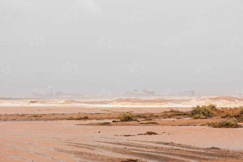 Rough muddy seas caused by Cyclone Sean- looking towards Chevron oil and gas, Onslow - Australian Stock Image