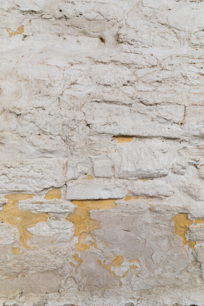 Rough white rendered stone brick wall - Australian Stock Image