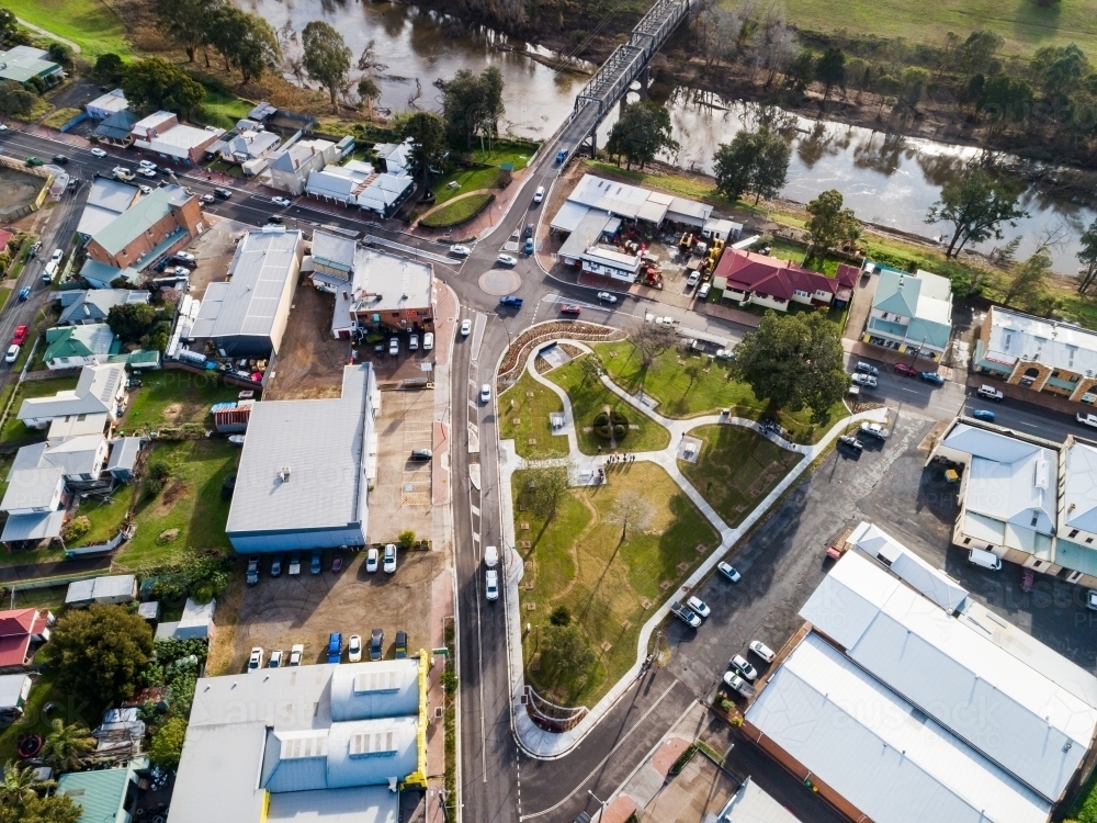 Roundabout and park with buildings beside Hunter river and bridge - Australian Stock Image