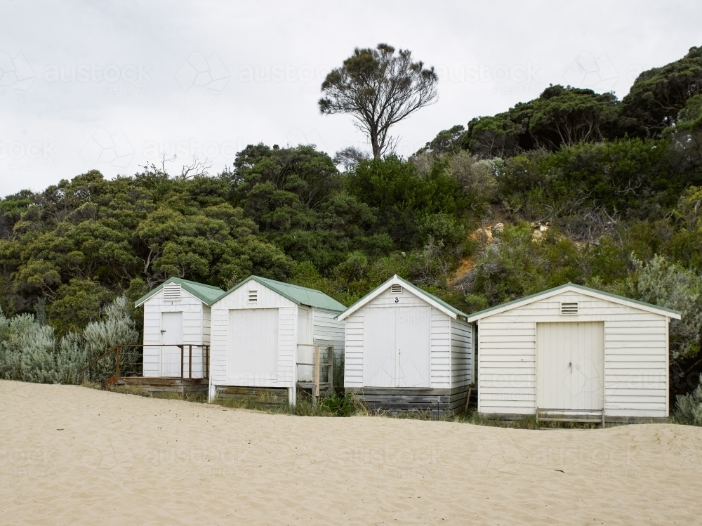 Row of beach boxes at a swimming beach - Australian Stock Image