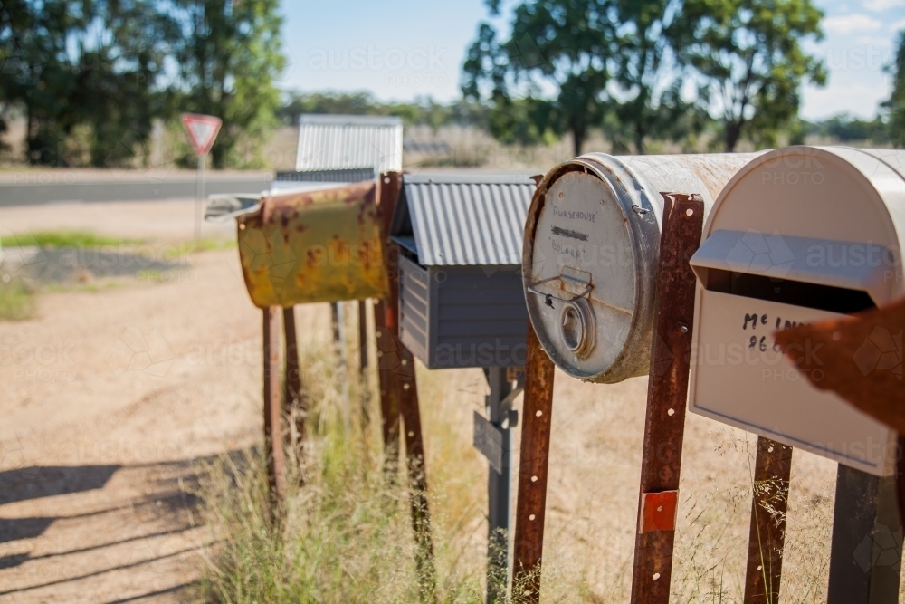 Row of country mailboxes on rural dirt road - Australian Stock Image