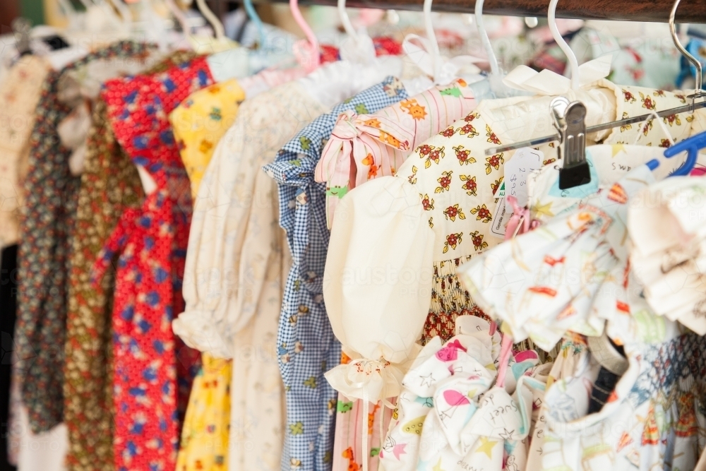 Row of pretty smocked little girls dresses - Australian Stock Image