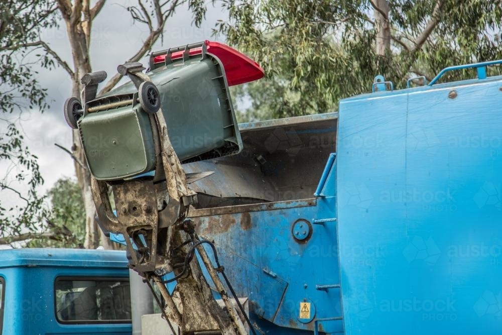 Rubbish being tipped into a garbage truck - Australian Stock Image