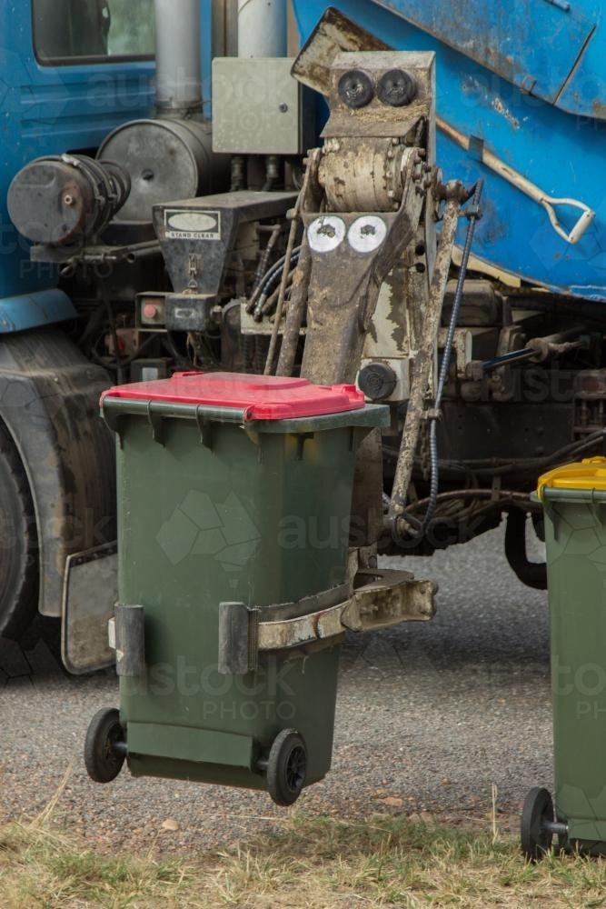 Image of Rubbish from bins being collected by garbage truck Austockphoto