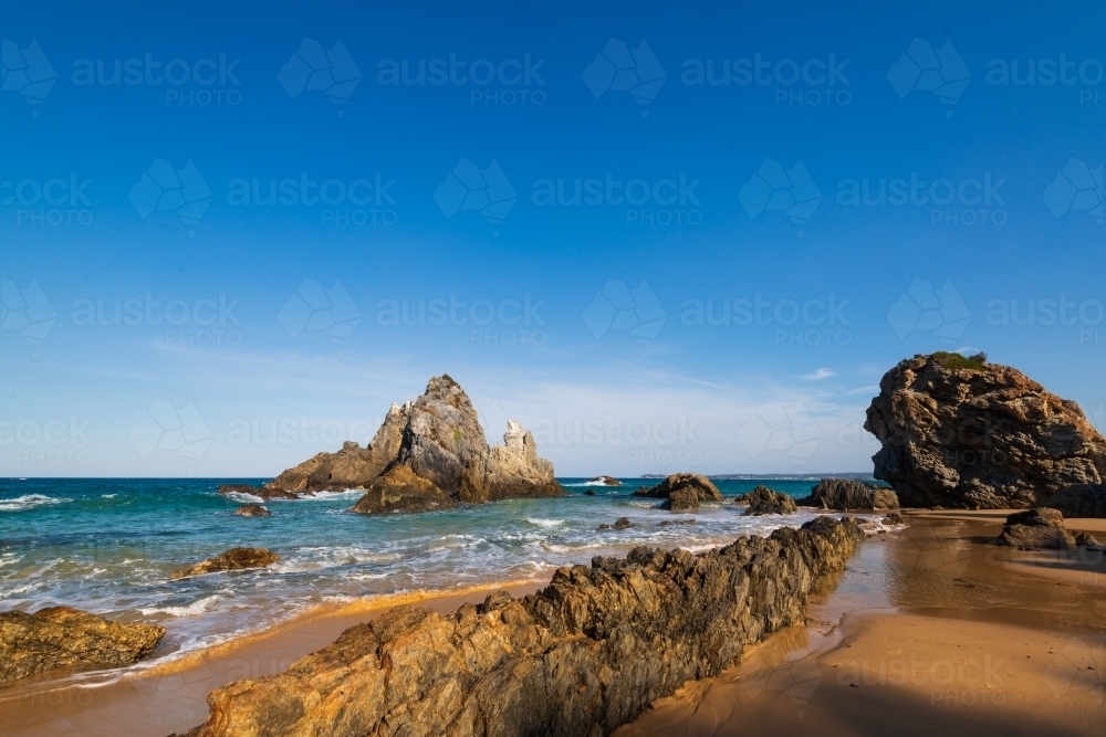 Rugged coastal scene with leading lines and clear blue sky - Australian Stock Image