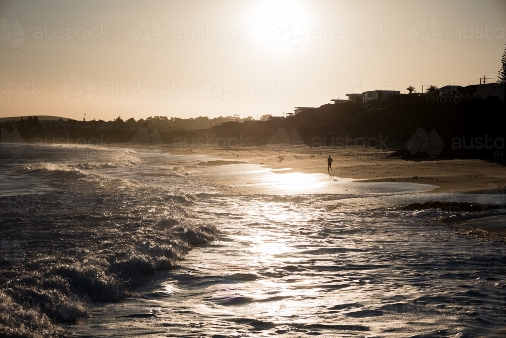 Running at sunset along Knights Beach - Australian Stock Image