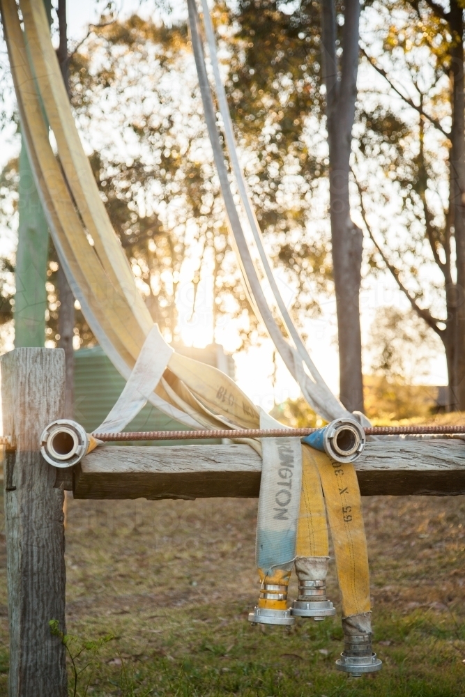 Rural fire service fire fighting hose draped on drying frame - Australian Stock Image