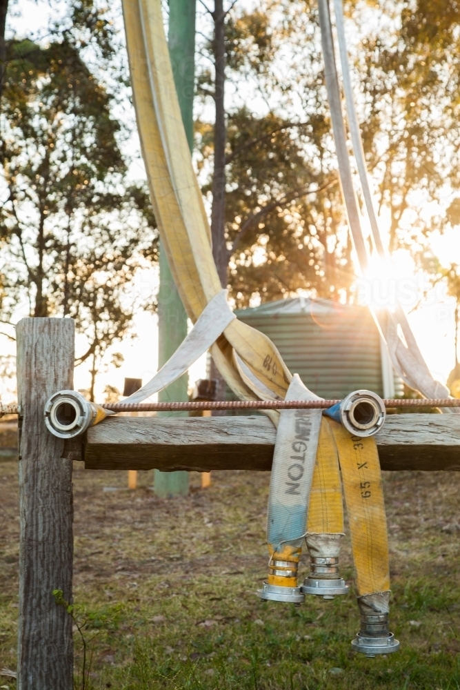 Rural fire service fire fighting hose draped on drying frame - Australian Stock Image