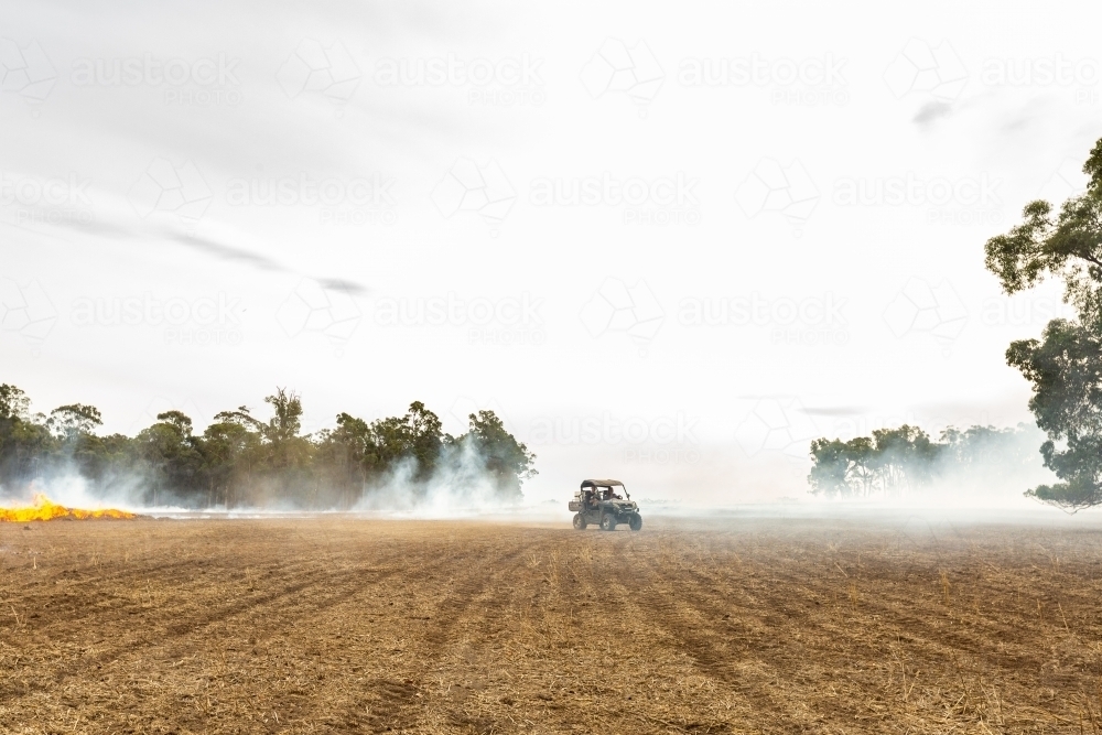 Rural scene with smoke from burning stubble - Australian Stock Image