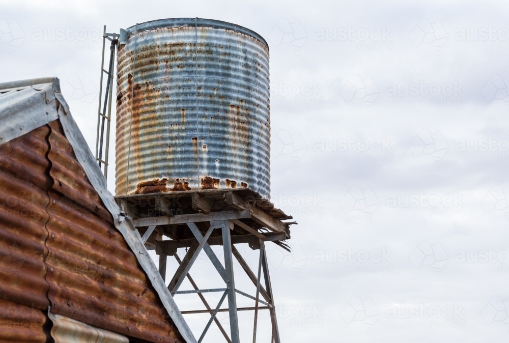 Rusty corrugated iron tank and shed - Australian Stock Image