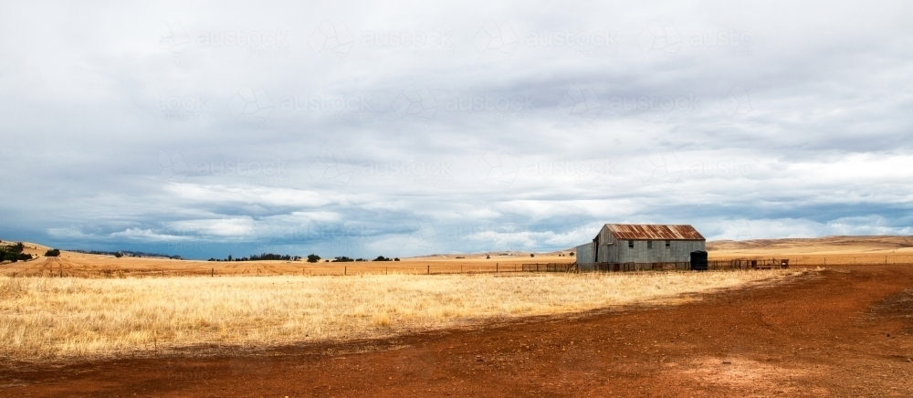 Rusty old shed in stubble paddock - Australian Stock Image