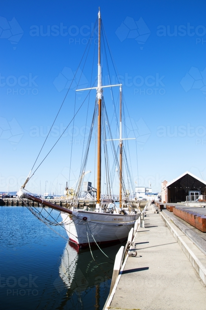 Sailboat docked at wharf - Australian Stock Image