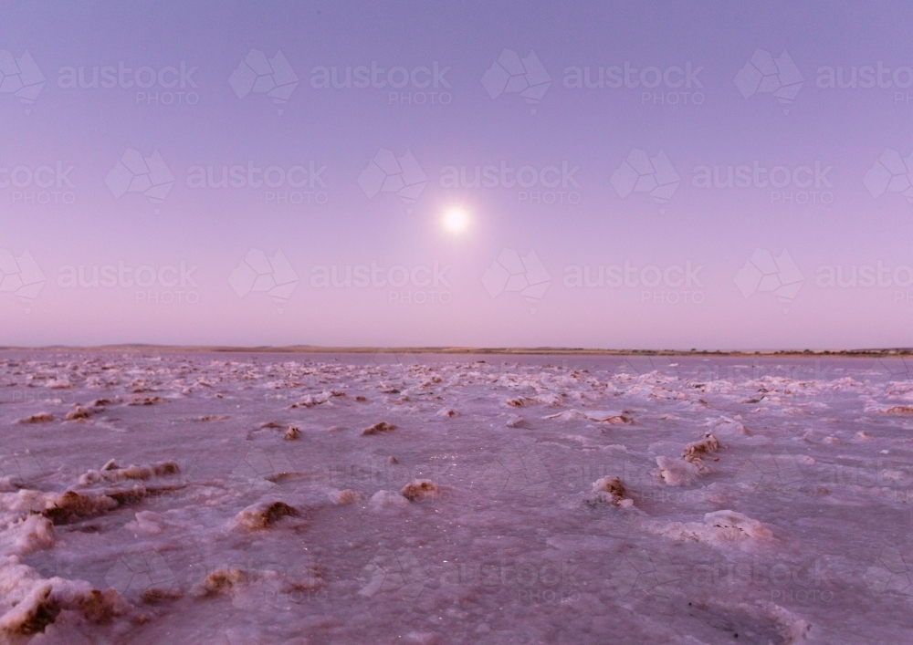 Salt flat foreground under a soft purple, pink sky. - Australian Stock Image