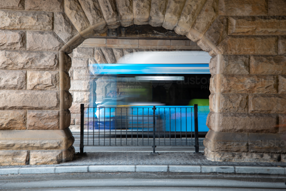 Sandstone arches under bridge with motion blur vehicles - Australian Stock Image