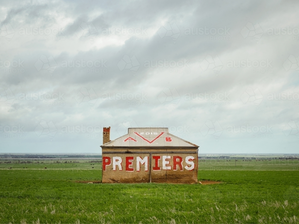 Sandstone cottage in field with graffiti - Australian Stock Image