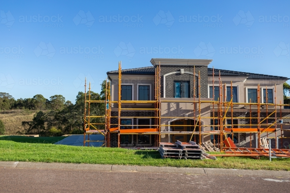 Scaffolding around almost completed house build on large property - Australian Stock Image