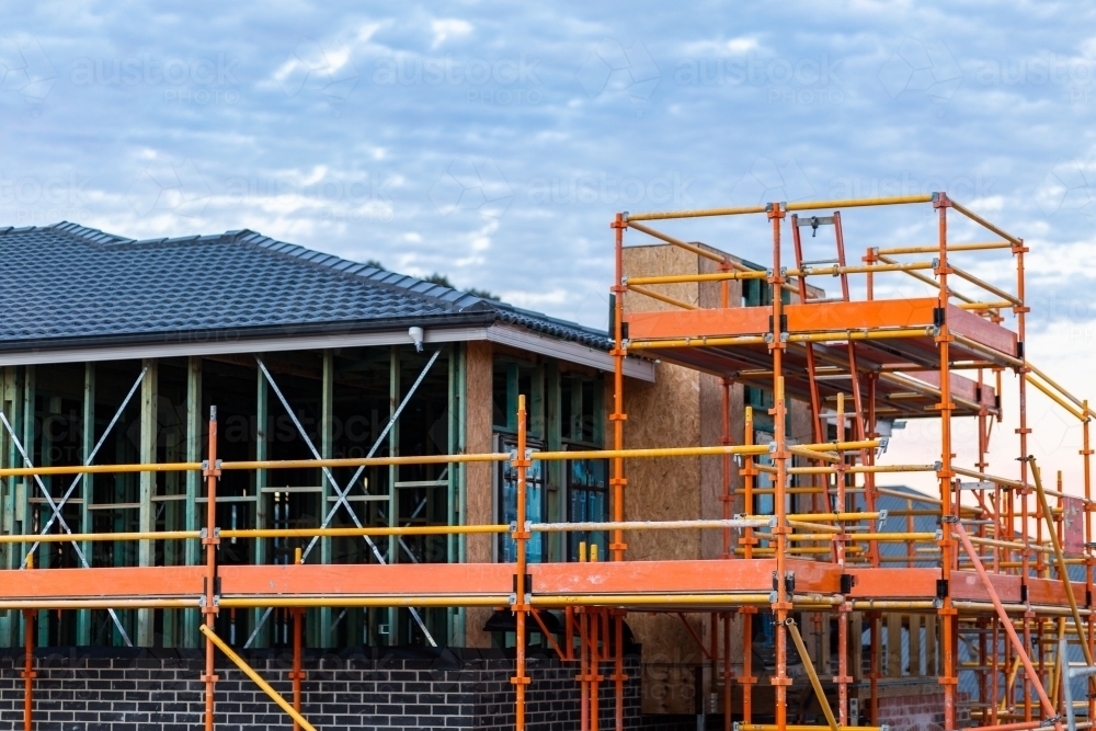 scaffolding surrounding double story new house build construction site - Australian Stock Image