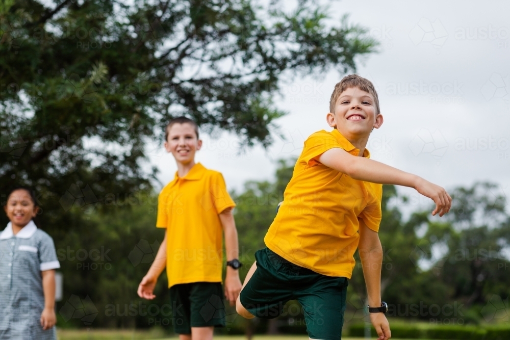 School boy after throwing a ball in sports game - Australian Stock Image