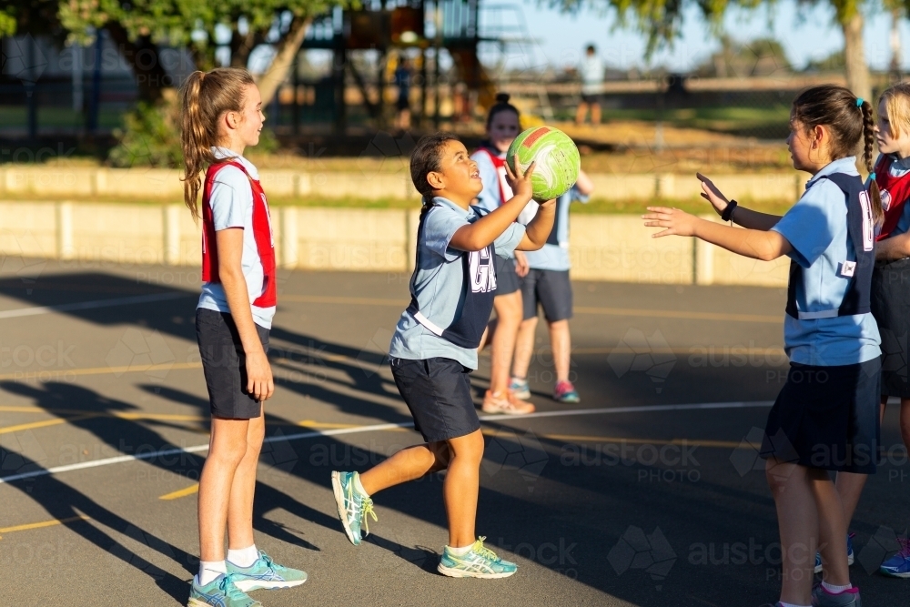 School children playing netball - Australian Stock Image