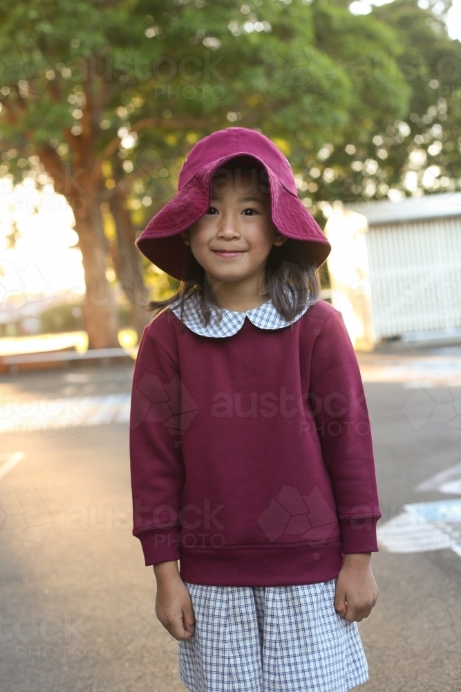 School girl wearing hat in playground - Australian Stock Image