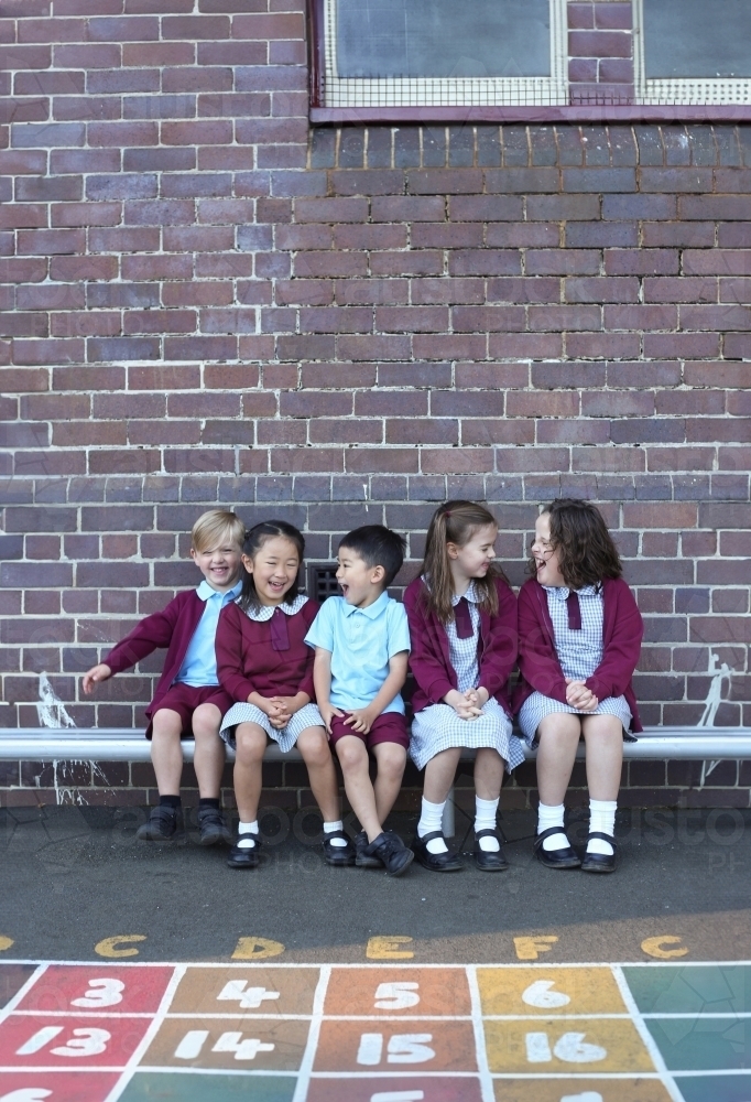 School kids talking and laughing in the school playground - Australian Stock Image