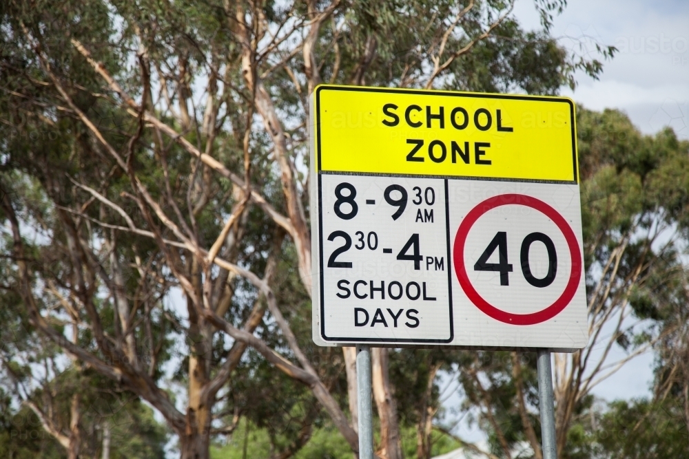 School Zone sign with gum tree background for small school - Australian Stock Image