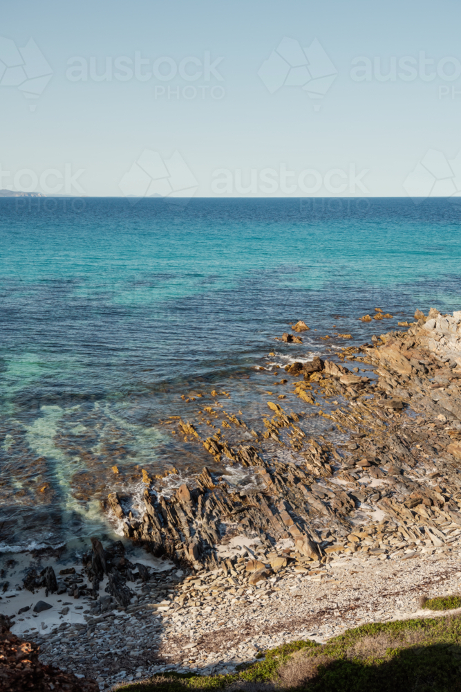 Seascape of rocky shoreline and blue water - Australian Stock Image