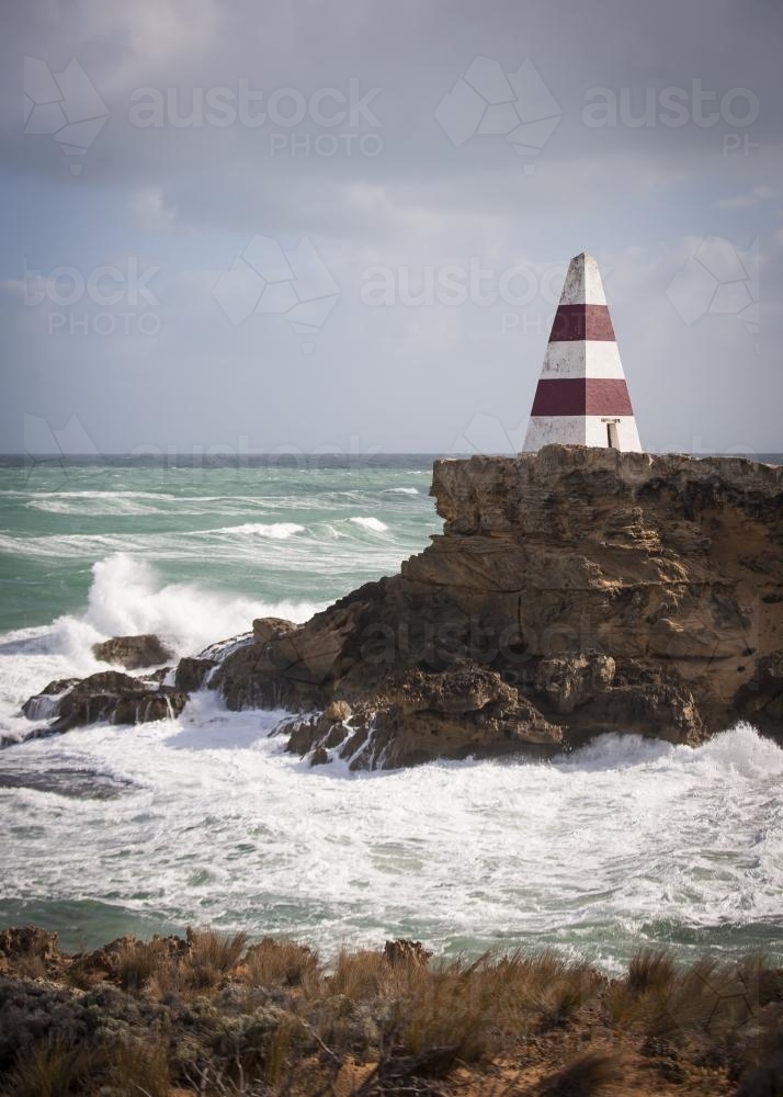 Seaside obelisk perched on the rocks at Cape Dombey - Australian Stock Image