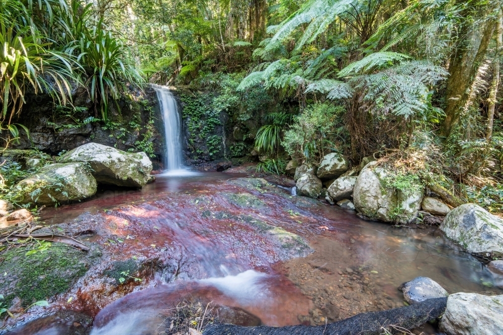 Secluded area with small waterfall flowing - Australian Stock Image